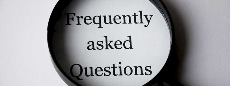 magnifying glass over typed words frequently asked questions