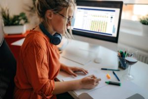 customer experience analytics data review on desktop with woman in foreground