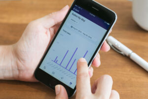 sales graphs on a mobile phone with consumer profile data